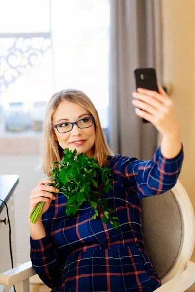 Young woman food blogger taking selfie photo with parsley in kitchen — Stock Photo, Image