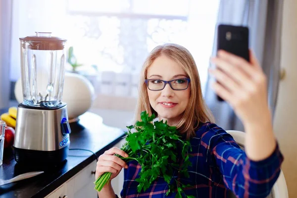 Young happy pregnant woman taking selfie photo with phone with green parsley — Stock Photo, Image