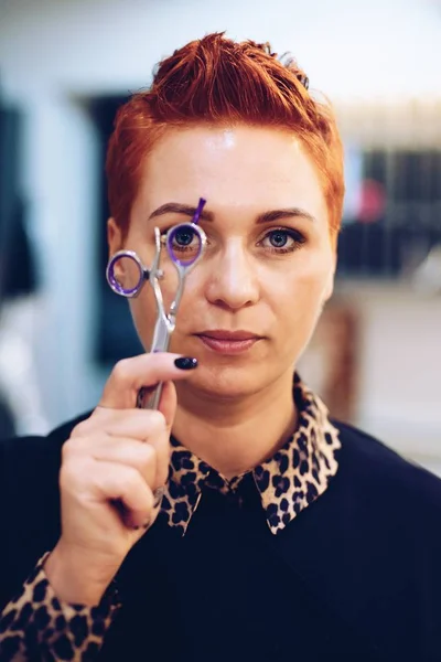 Female hairdresser posing with scissors — Stock Photo, Image