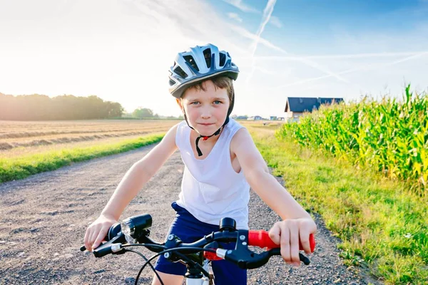 Little child boy in white helmet riding his bicycle — Stock Photo, Image