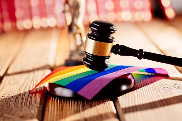 Judge wooden mallet - symbol of law and justice with lgbt rainbow colours flag