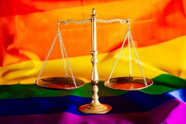 Scales of justice symbol of law and justice with lgbt flag