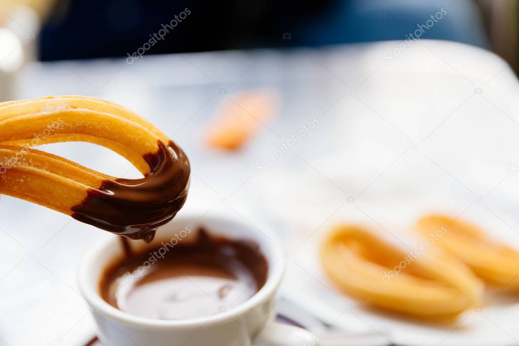 Delicious Spanish dessert churros with chocolate sauce