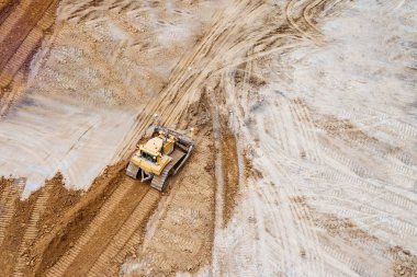 Şantiyede çalışan buldozerde havadan drone görünümü.