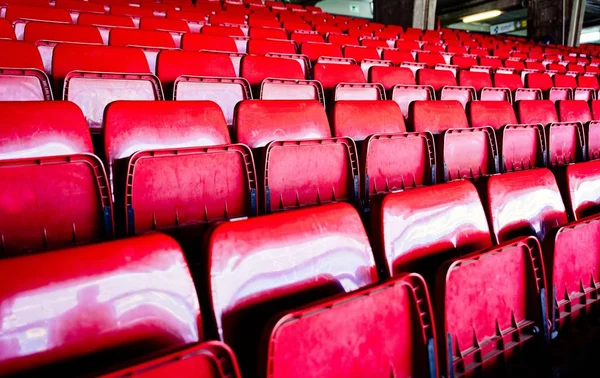 Red plastic empty stadium seats.