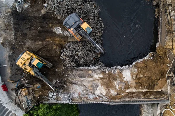 Aerial drone view on excavators demolishing a road bridge. — Stock Photo, Image