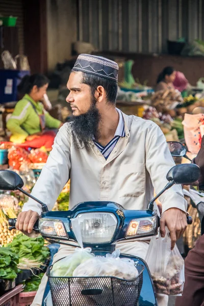 Muslim man on motorbike. — Stock Photo, Image