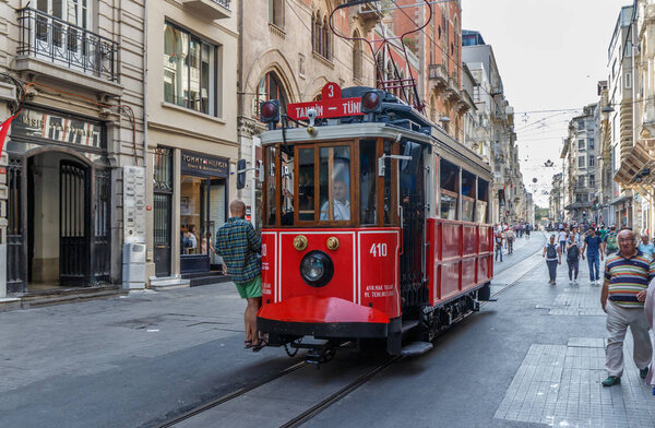 A vintage tram rides down the main street