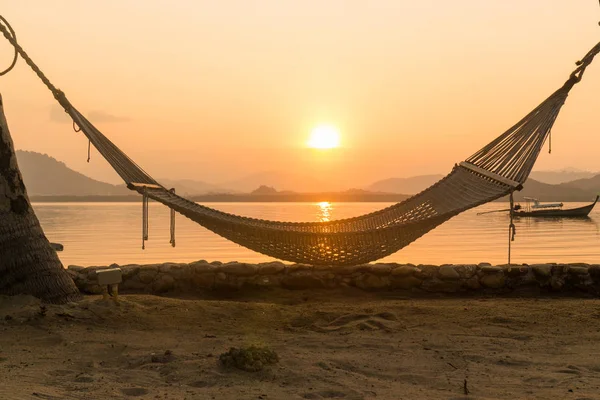 Hammock on beach at sunset in Phuket, Thailand