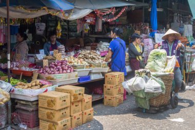 Bir hamal bir müşteri Khlong Toei sebze satın olarak standları 