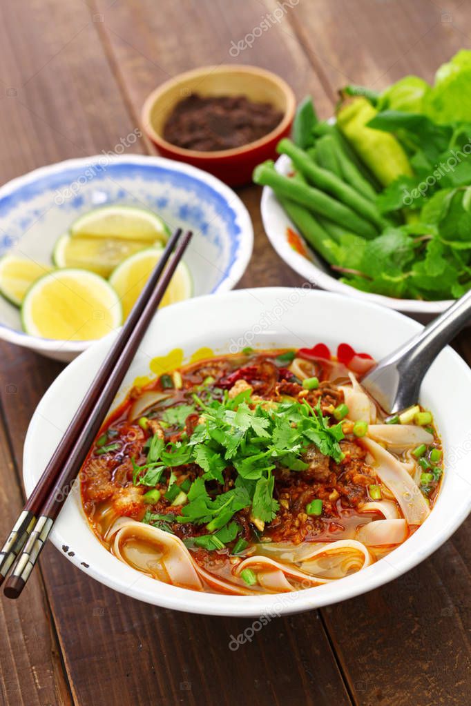 Lao khao soi, wide rice noodles soup with spicy minced pork, laos food