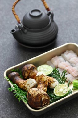 dobin mushi (Japanese cuisine) : steamed matsutake mushroom and pike conger with Japanese broth in an earthenware teapot and served. clipart