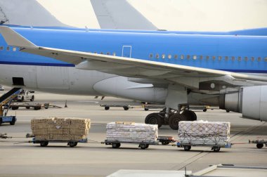 Airfreight at an airport with parked airplanes  clipart