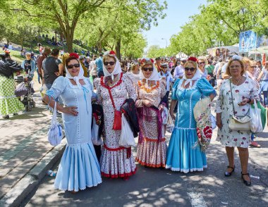 Madrid, Spain - May 15, 2018. Citizens dressed as Chulapas honours its patron, Saint San Isidro at festivity of San Isidro Labrador, in Pradera de San Isidro park of Madrid. clipart