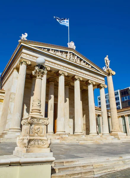 Principal facade of The Academy of Athens, Greece National academy, with Apollo pillar in background. Athens, Attica region, Greece.