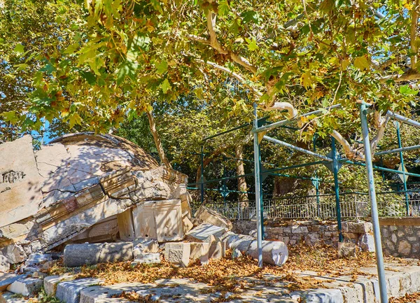 The Tree of Hippocrates, a plane tree under which Hippocrates of Kos taught his pupils the art of medicine. And the template of Gazi Hassan Pasha mosque damaged by the earthquake which struck on 21 July 2017. Square of the Platane, Kos. Greece.