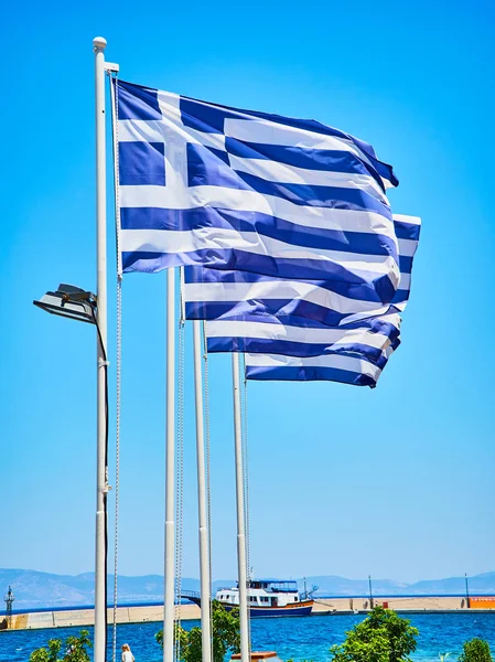 Four Official Flags Greece Waving Blue Sky Seascape Background — Stock Photo, Image