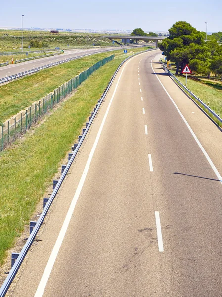 A European highway without traffic on a sunny day.