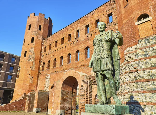 Gaius Julius Caesar Statue in front of Porta Palatina Gate. Piazza Cesare Augusto square. Turin, Piedmont, Italy.