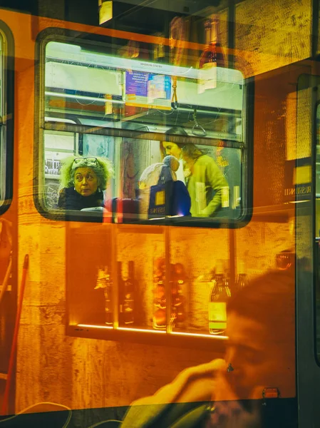 ミラノ イタリア 2018 夜のミラノの市民を運ぶ電車 ロンバルディア州 イタリア バーの店先のリフレクションを介して表示します — ストック写真