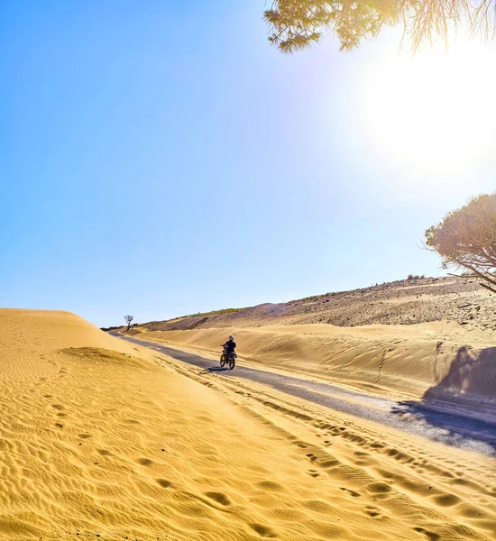 Moto traversant un terrain de dunes arides . — Photo