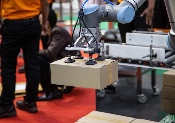 The Universal Robot  collaborative industrial robot arm lifing box