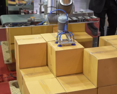 The universal robot lifting carton clipart