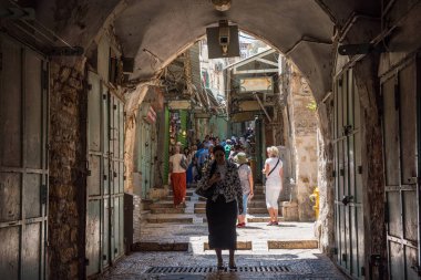 JERUSALEM, ISRAEL - MAY 15, 2018: Christian pilgrims crossing the Via Dolorosa, believed to be the path that Jesus walked on the way to his crucifixion clipart