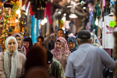 JERUSALEM, ISRAEL - MAY 16, 2018: Palestinian locals of Jerusalem shopping in the traditional bazaar in the Muslim quarter of Jerusalem  clipart