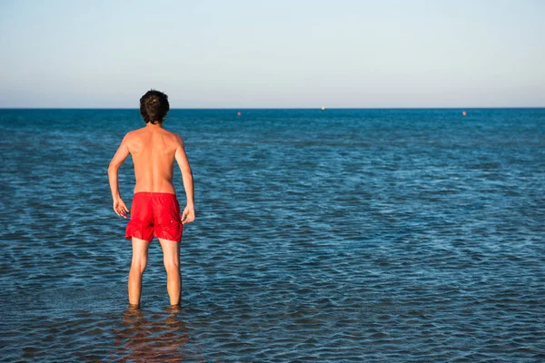 Slim Guy Posing Red Swimwear Sea Water Parody Concept — Stock Photo, Image