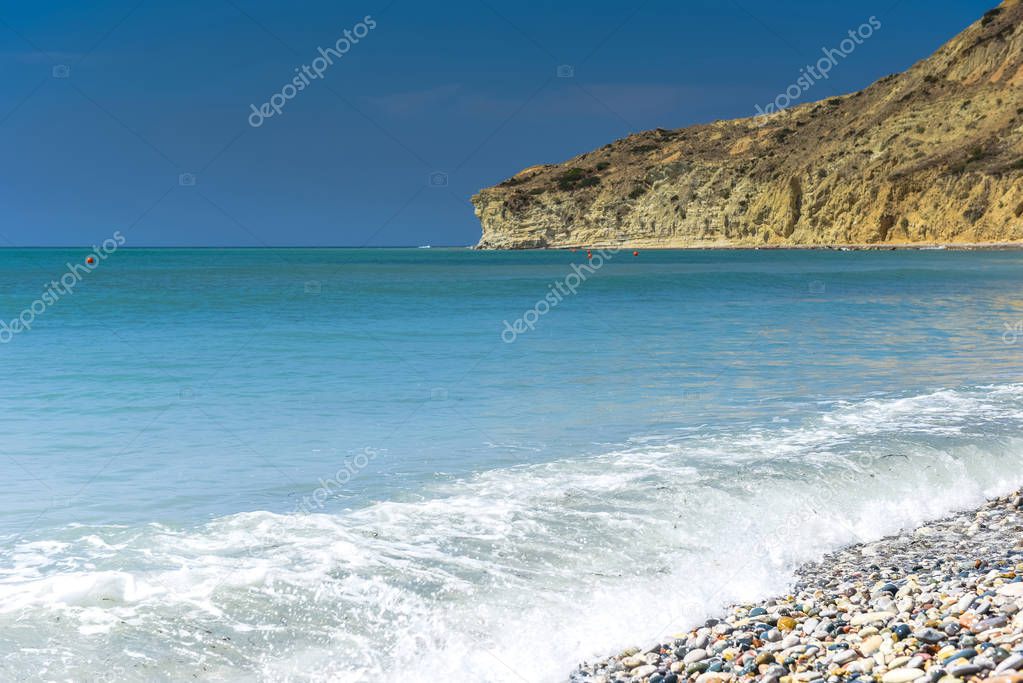 Idyllic calm tropical beach with turquoise sea water and pebble stones