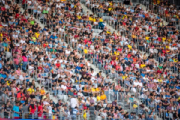 Crowd of blurred football spectators at the stadium