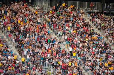 CLUJ, ROMANIA - JUNE 16, 2018: Crowd of people, soccer fans in the tribune supporting their favorites at a match between Romania Golden Team and Barcelona Legends
