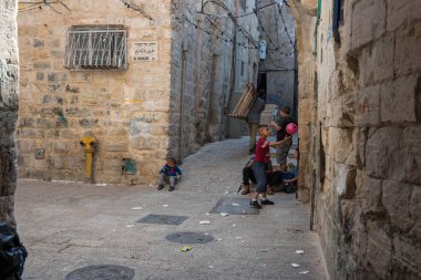 JERUSALEM, ISRAEL - MAY 15, 2018: Local Palestinian children playing in the Muslim Quarter of the city clipart