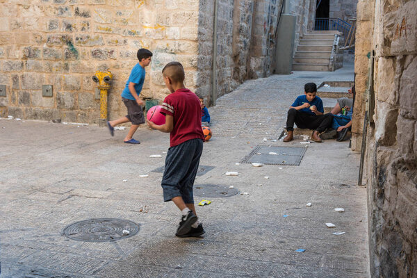 JERUSALEM, ISRAEL - MAY 15, 2018: Local Palestinian children playing in the Muslim Quarter of the city