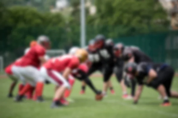 Blurred American football players in action during a match