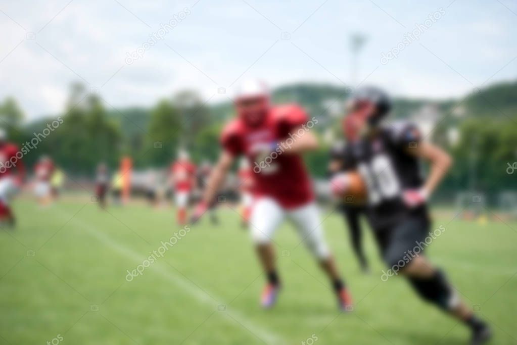 Blurred American football players in action during a match
