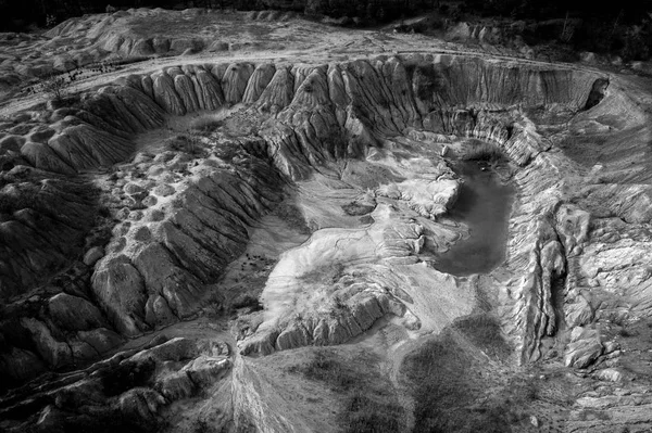 Black and white image of abandoned industrial exploitation, opencast mine. Aerial drone view