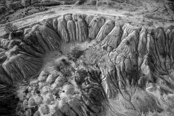 Black and white image of abandoned industrial exploitation, opencast mine. Aerial drone view