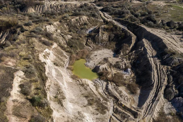 Industrial mining landscape from a drone. Aerial view of an abandoned open pit mine, nature pollution
