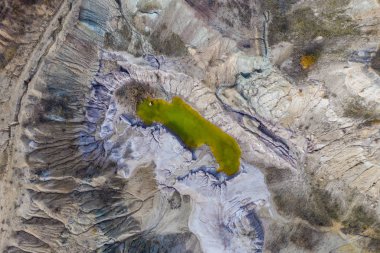 Terk edilmiş endüstriyel maden bölgesi. Açılmış mayının drone görüntüsü suyla dolu. Yapay gölün hava görüntüsü