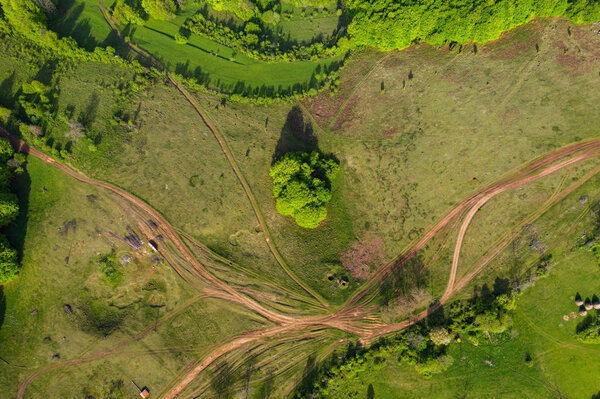 Aerial view of a countryside rural dirt road by drone