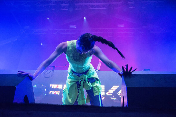 Woman performer singing on stage