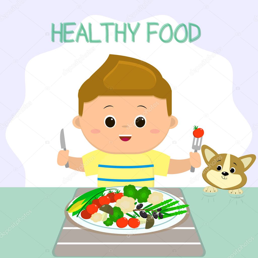 A boy in a T-shirt is sitting at a table, a plate of vegetables. The puppy looks like shit. Healthy food, organic products.