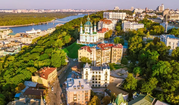 Aerial drone view of Saint Andrew's church and Andreevska street from above, cityscape of Podol district on sunset, skyline of city of Kiev (Kyiv), Ukraine