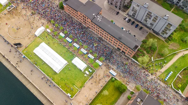 Marathon running race, aerial view of start and finish line with many runners from above, road racing, sport competition, Copenhagen marathon, Denmark