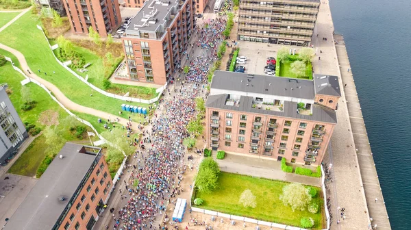 Marathon running race, aerial view of start and finish line with many runners from above, road racing, sport competition, Copenhagen marathon, Denmark