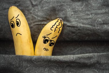 In bed, on the dark sheets, two bananas, a husband and wife. Tiff, resentment, resentment partner. The picture is made by the author. clipart