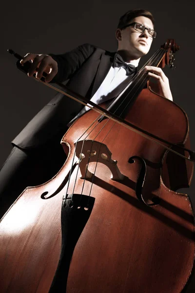 Double bass player contrabass playing. Classical musician jazz bassist. Cello