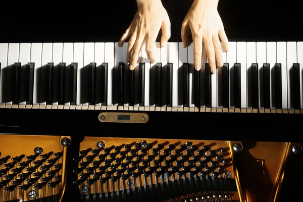 Piano keys closeup. Piano player. Pianist hands playing grand piano